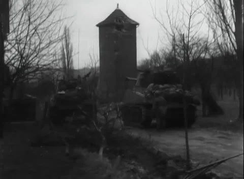 GERMANY - 1945: Shattered window frame - Armour parks beneath the stone tower Video stock 344600120