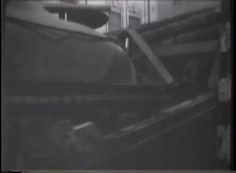 GERMANY - 1945: Shuttered facade view - Tank pushes through timber and rubble Stock Footage 344600447