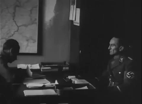 GERMANY - 1945: Silhouette against a map - Men confer over papers in an office Stock Footage 344598850
