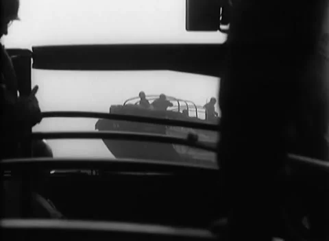 GERMANY - 1945: Standing figures in haze - Hazy bank beyond the black deck Stock Footage 344600369