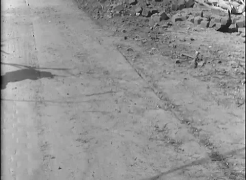 GERMANY - 1945: Tramway ruins - Infantry advance beside a civilian man Stock Footage 344488451