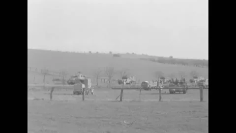 GERMANY - 1945 - US medics help a wounded German POW and US soldiers drive Видео 284637944