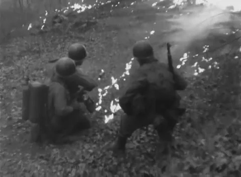 GERMANY - 1945: Weapons training - 94th flamethrower drill ignites slope Stock Footage 344492688
