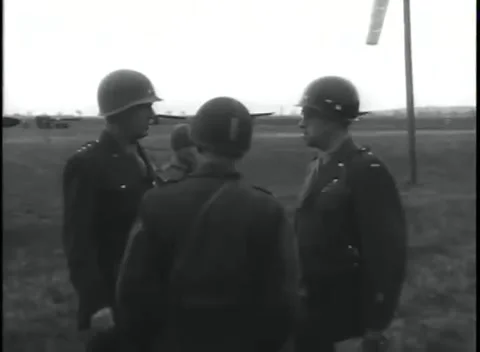 GERMANY - 1945: Windsock and vehicles - Officers meet between two canvas tents Stock Footage 344598443