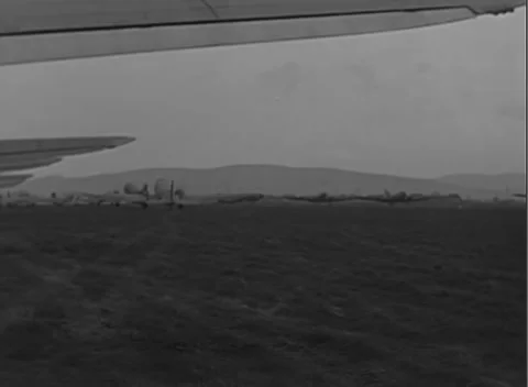GERMANY - 1945: Windsock - C-47 approaches between parked aircraft Stock Footage 344487523