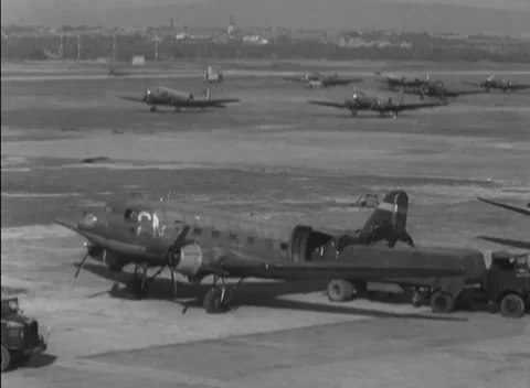 GERMANY - 1948: Apron loading point - Freight waits beside a line of transports Stock Footage 344496248