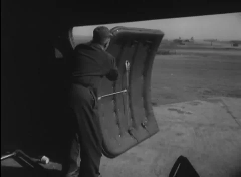 GERMANY - 1948: Loading hardware - Crew handles freight and a raised metal panel Stock-Footage 344496299