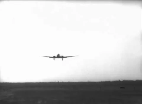 GERMANY - 1948: Low airborne pass - Skytrain approaches beneath a white sky Stock Footage 344496073