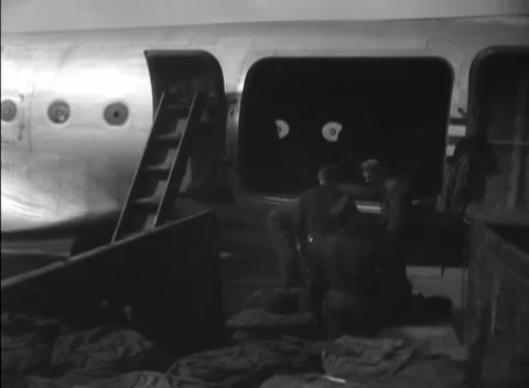 GERMANY - 1948: Manual loading - Ground crew pass sacks into a transport Stock Footage 344496294