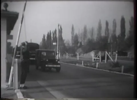 GERMANY - 1949: Striped gate - Cargo truck passes sentry at road checkpoint Stock Footage 344495600