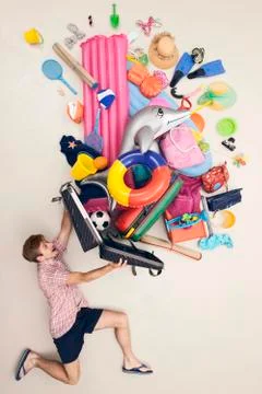 Germany, Artificial scene with man opening baggage full of beach toys Stock Photos