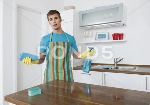 Germany, Augsburg, Man cleaning kitchen counter Stock Photos