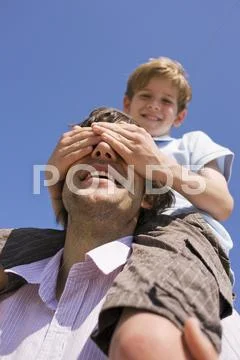 Germany, Baltic sea, Father carrying son (8-9), portrait Stock Photos