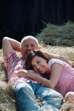 Germany, Bavaria, Couple lying on haystack Stock Photos