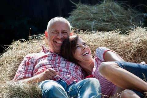 Germany, Bavaria, Couple lying on haystack Stock Photos