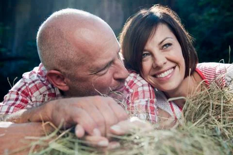Germany, Bavaria, Couple lying on haystack Stock Photos