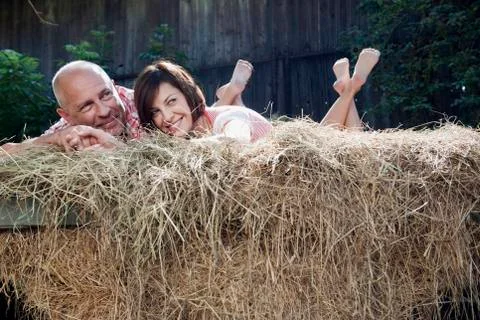 Germany, Bavaria, Couple lying on haystack Stock Photos