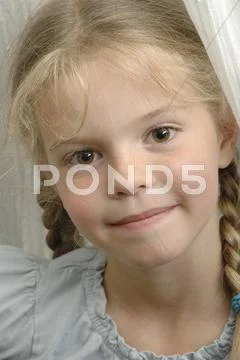 Germany, Bavaria, Girl playing hide and seek, close up Stock Photos