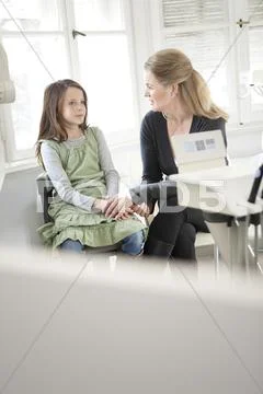 Germany, Bavaria, Landsberg, Mother comforting daughter (8-9) in dental surgery Stock Photos
