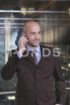 Germany, Bavaria, Munich, Business man at subway station using mobile phone, Stock Photos