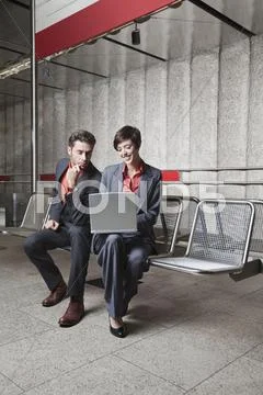Germany, Bavaria, Munich, Business people at underground station platform using Stock Photos