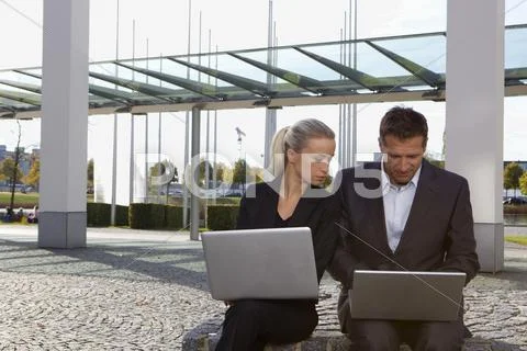 Germany, Bavaria, Munich, Business people using laptop Stock Photos