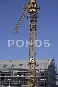 Germany, Bavaria, Munich, Construction crane next to building Stock Photos