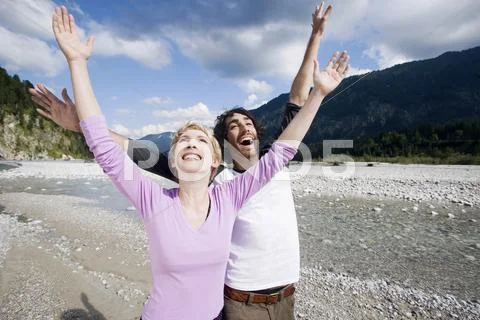Germany, Bavaria, Tolzer Land, Young couple cheering Stock Photos