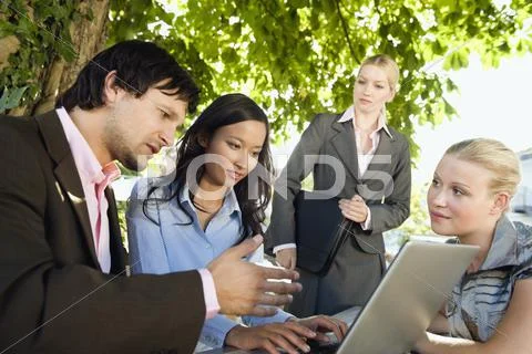 Germany, Bavaria, Upper Bavaria, Business people using laptop in beer garden Stock Photos