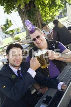 Germany, Bavaria, Upper Bavaria, Businessman and punk in beer garden, elevated Stock Photos