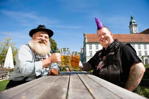 Germany, Bavaria, Upper Bavaria, Man with mohawk hairstyle and Bavarian man in Stock Photos