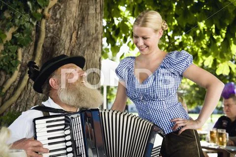 Germany, Bavaria, Upper Bavaria, Senior man in traditional costume playing Stock Photos