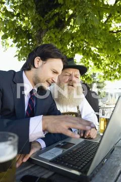 Germany, Bavaria, Upper Bavaria, Senior Bavarian man and young businessman with Stock Photos