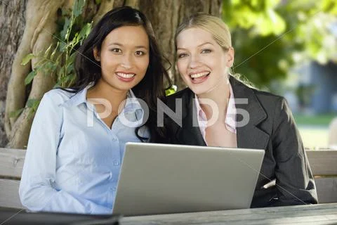 Germany, Bavaria, Upper Bavaria, Two Business women in beergarden using laptop Stock Photos