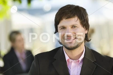 Germany, Bavaria, Upper Bavaria, Young businessman in beer garden, portrait Stock Photos