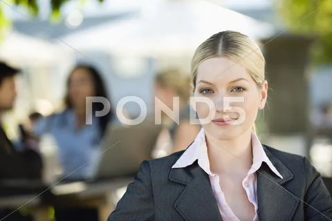 Germany, Bavaria, Upper Bavaria, Young businesswoman in beer garden, portrait, Stock Photos