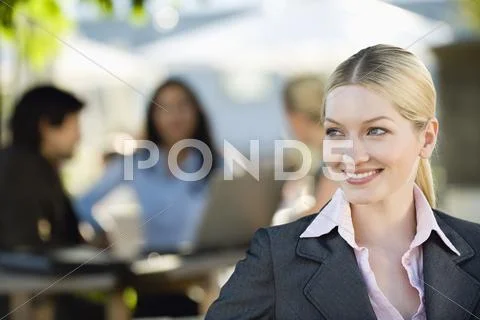 Germany, Bavaria, Upper Bavaria, Young businesswoman in beer garden, portrait, Stock Photos