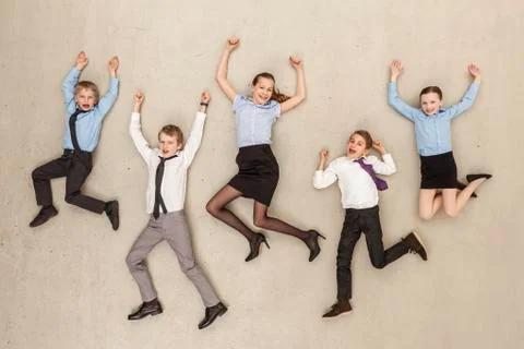 Germany, Berlin, Business kids flying against beige background Stock Photos
