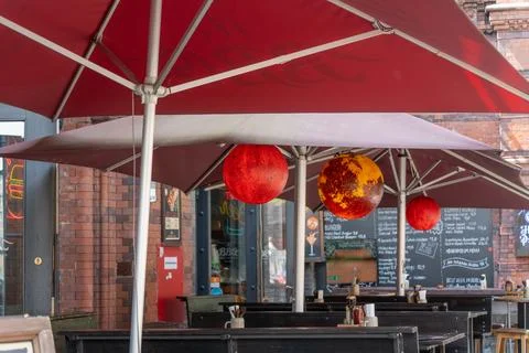 Germany, Berlin, June 2, 2026. Restaurant Terrace With Red Umbrellas and Hanging Stock Photos