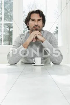 Germany, Berlin, Mature man with coffee cup, portrait Stock Photos