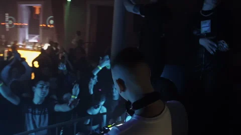 Germany, Berlin - May 14, 2023: Crowd of people in nightclub with DJ. Clip. DJ Video stock 245753990