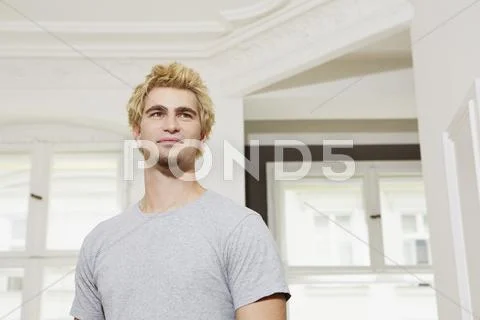 Germany, Berlin, Young man looking away, smiling Stock Photos
