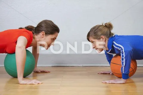 Germany, Berlin, Young women exercising in school gym Stock Photos
