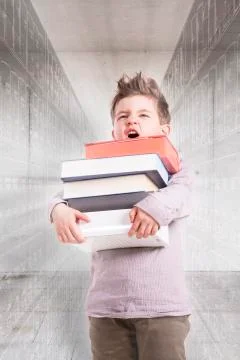 Germany, Brandenburg, Boy holding stack of books Foto stock