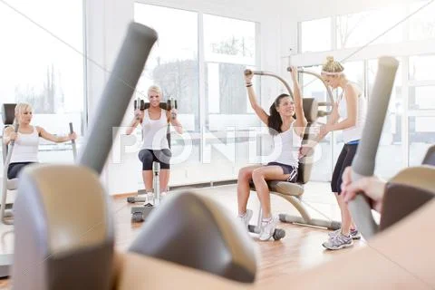 Germany, Brandenburg, Instructor with women exercising in gym Stock Photos