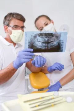Germany, Brandenburg, Strausberg, Dental colleagues discussing x ray picture Stock Photos