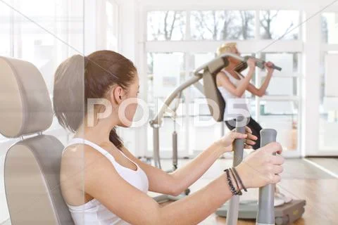 Germany, Brandenburg, Young women exercising in gym Stock Photos