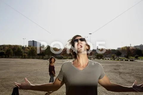 Germany, Cologne, Man shouting and woman standing in background Stock Photos