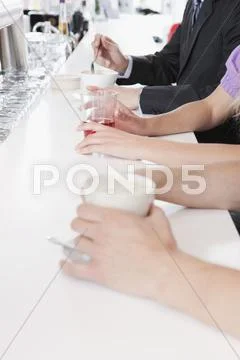 Germany, Cologne, People sitting at bar counter Stock Photos