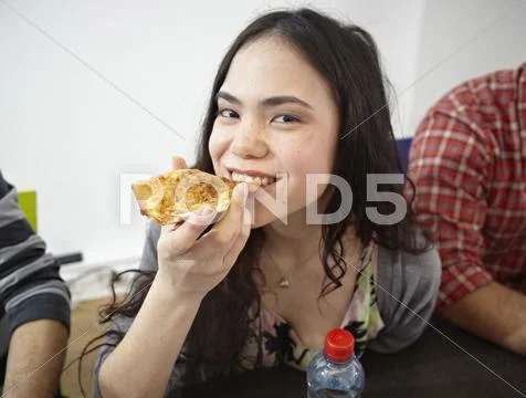 Germany, Cologne, Woman eating pizza Stock Photos